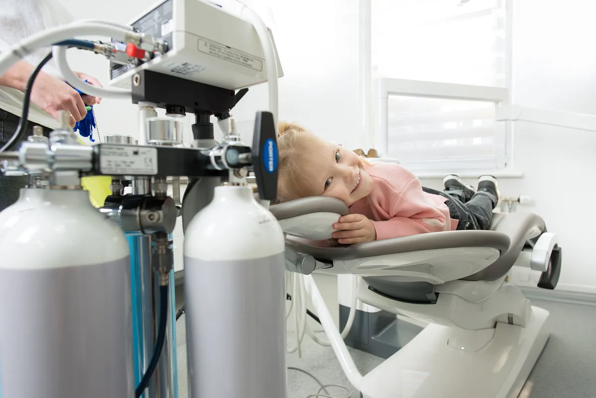 A young child lying relaxed in the dental chair